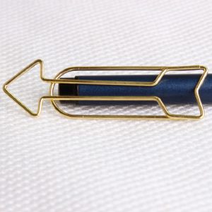 Arrow Shaped Golden Metal Paperclip In A Box