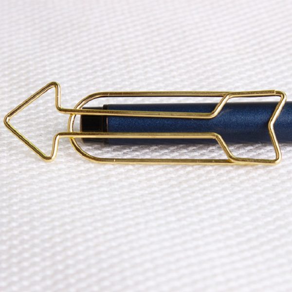 Arrow Shaped Golden Metal Paperclip In A Box
