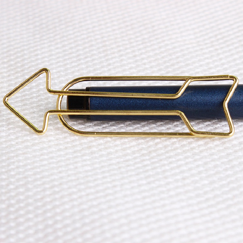 Arrow Shaped Golden Metal Paperclip In A Box