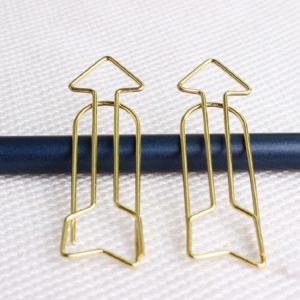 Arrow Shaped Golden Metal Paperclip In A Box