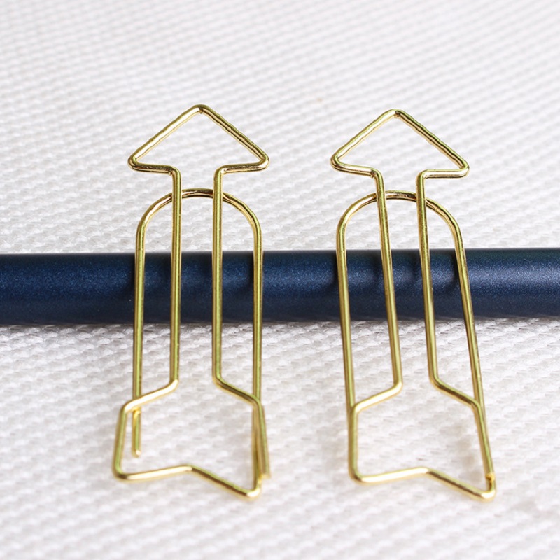 Arrow Shaped Golden Metal Paperclip In A Box