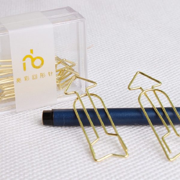 Arrow Shaped Golden Metal Paperclip In A Box